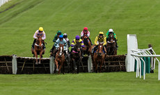 A view of the field clearing a hurdle during the race 12/3/2024