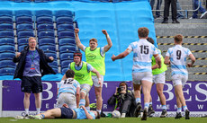 Blackrock players, subs and staff celebrate as Mark Walsh runs in to score a try 17/3/2024