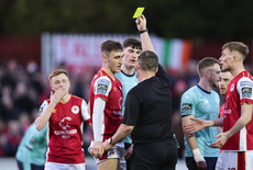 Mason Melia is shown a yellow card by  David Dunne 19/4/2024