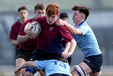 Rian Collins is tackled by Dylan O Connelly and Evan McDonagh 24/4/2024