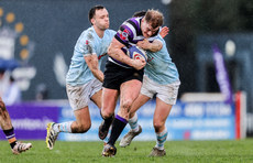 Colm de Buitlear is tackled by Ed Barryand Nick Greene 25/3/2023