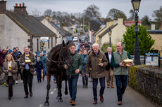 Willie Mullins parades Galopin Des Champs through the village of Leighlinbridge alongside groom Adam Connolly, Shane Jones and owner Greg and Audrey Turley 19/3/2024