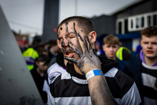 James Murphy paints the faces of fellow school mates as they arrive for the game 12/3/2024