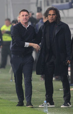 Robbie Keane shakes hands with Christian Karembeu after the game 14/3/2024