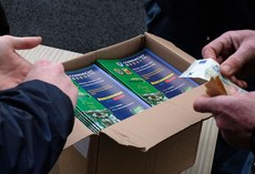 A spectator purchases a program before the game 2/4/2016