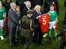 President Michael D Higgins holds up a jersey presented by Wales in tribute to Ryan McBride 24/3/2017