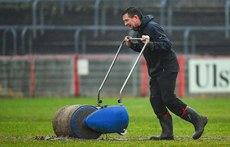 A groundskeeper works on the pitch before the game 16/3/2024