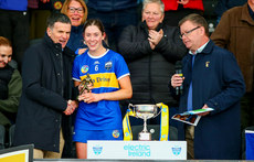 Pat Fenton, executive director of Electric Ireland presents the player of the match trophy to Tipperary's Sarah Corcoran 27/4/2024