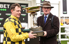 Paul Townend and Willie Mullins lift the Champion Hurdle Challenge Trophy after winning with State Man 12/3/2024