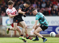 Eoin Duffy is challenged by Ronan Canavan and Jack McCloy 7/7/2024