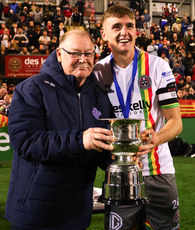 Cian Byrne is presented with the cup by former Leinster Football Association President Tony Martin 18/9/2023