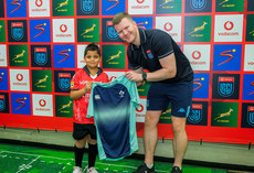 Eoghan Cross presents a jersey to a young mascot during the coin toss 11/5/2024 