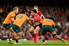 Ben Thomas is tackled by Len Ikitau and Rob Valetini 17/11/2024