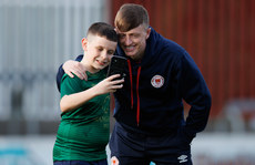 Chris Forrester poses for a photo with a fan ahead of the game 19/4/2024