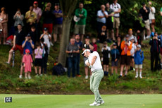 Rory McIlroy takes a shot from the drop zone after hitting the water on the 8th 10/9/2023