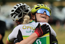 Caoimhe May is congratulated by Niamh McKiverigan after the race 24/7/2022