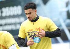Sam Durrant warms up ahead of the game in a Darkness Into Light branded t-shirt 6/5/2024