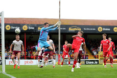 Evan Caffrey scores his sides second goal despite the efforts of Brendan Clarke 28/6/2024