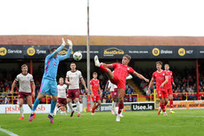 Evan Caffrey scores his sides second goal despite the efforts of Brendan Clarke 28/6/2024