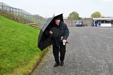 A supporters takes shelter from the wind as he arrives at Dr. Hyde Park ahead of the game 
20/10/2024 