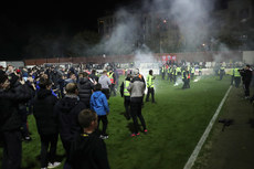 Flares are thrown onto the pitch after the game 25/10/2024