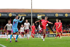 Evan Caffrey scores his sides second goal despite the efforts of Brendan Clarke 28/6/2024