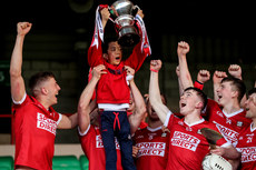 The Cork team lift Jamie Cashman with the Munster U20 trophy as Munster Under 20 champions 15/5/2023 