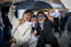 Racegoers shelter from the showers 10/4/2023
