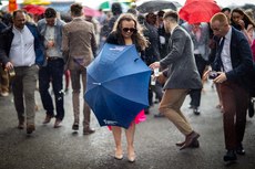 Racegoers shelter from the showers 10/4/2023
