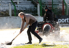 Volunteers and officials at Glentoran try to clear the pitch ahead of tonight’s match 10/3/2023