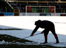 Volunteers and officials at Glentoran try to clear the pitch ahead of tonight’s match 10/3/2023