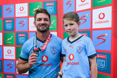 Ruan Vermaak is presented with the player of the match award by a young mascot 11/5/2024