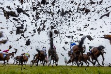 A general view as the runners and riders clear the first fence in The BoyleSports Irish Grand National Steeplechase 1/4/2024