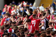 A steward crowdsurfs with Cork fans after the game 19/5/2024