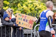 A young spectator holds a sign for participants 27/10/2024 