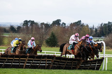 Sam Ewing onboard Helvic Dream (Left of picture, sky blue and pink) on the last hurdle, eventually going on to win the race 11/2/2024