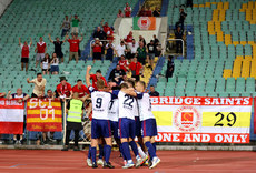 Serge Atakayi celebrates scoring the late goal to win the game with teammates in front of their travelling fans 4/8/2022