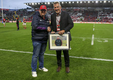Rob Penney is presented with a framed photo before the game 3/2/2024
